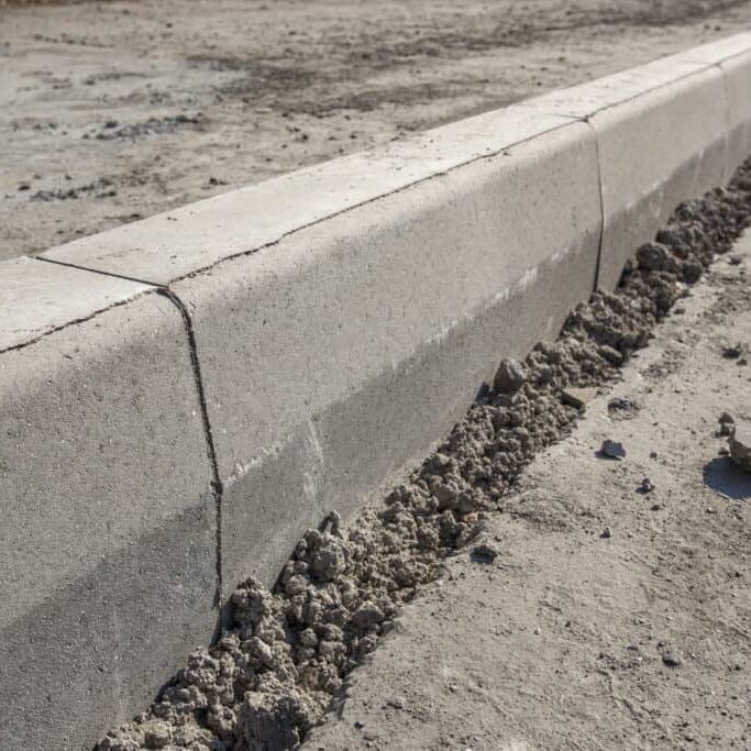 Sidewalk under construction, concrete curb installation in progress. Sidewalk under construction, concrete curb installation in progress.
